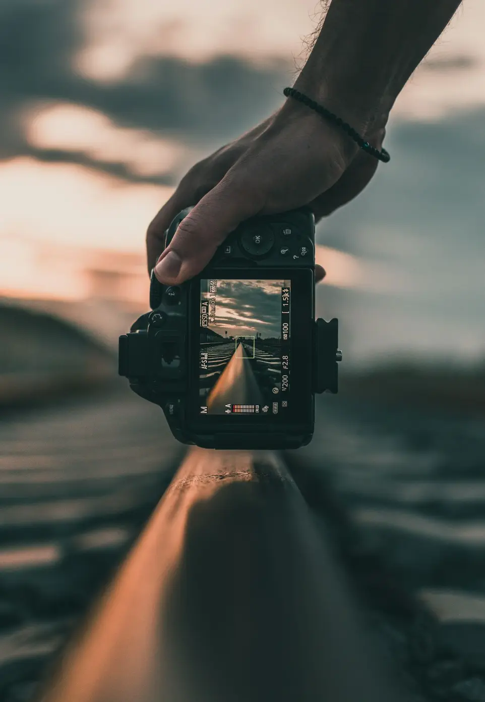 person holding black dslr camera during daytime